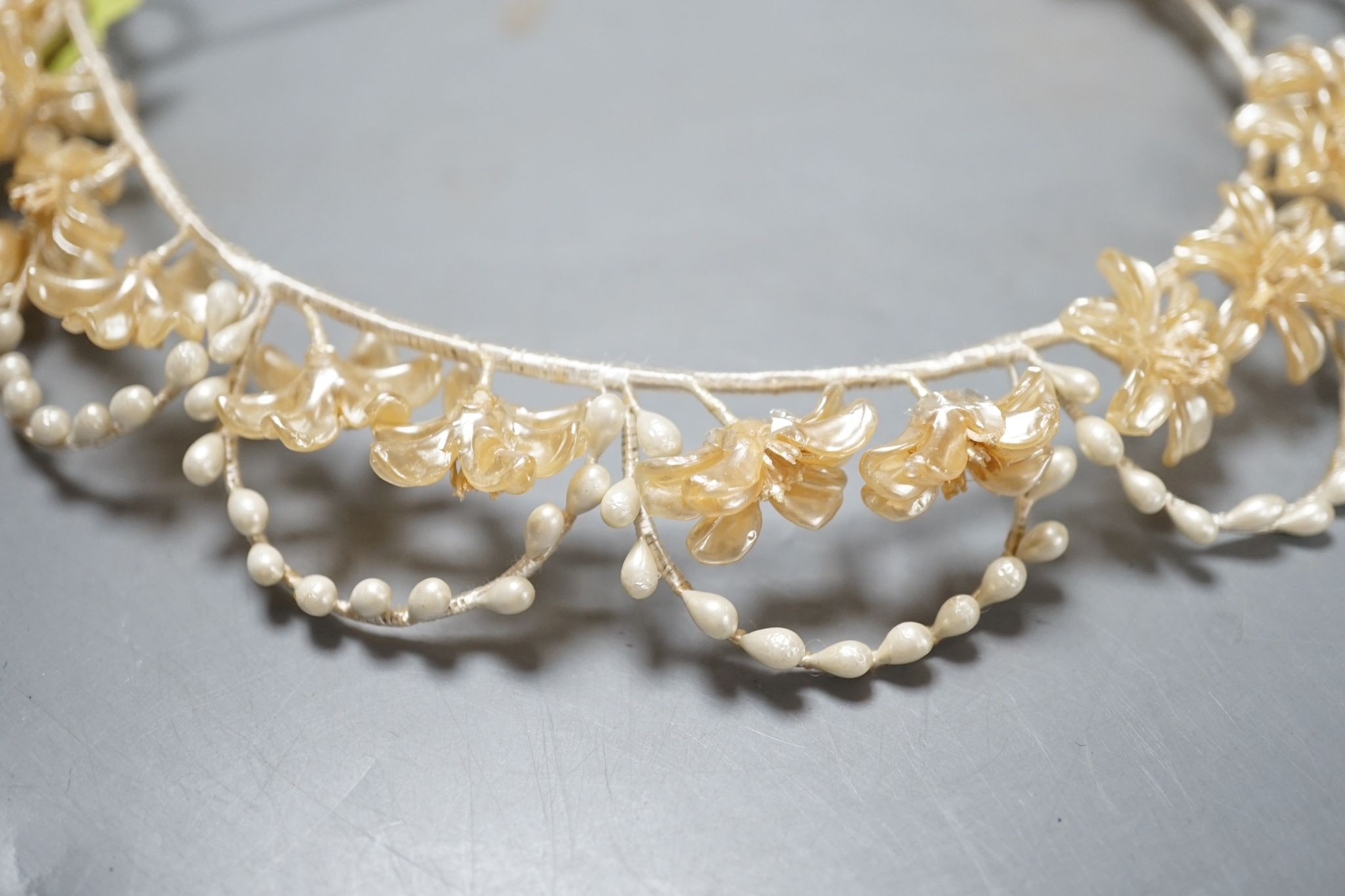 A late 1930's- 40's cream machine lace wedding dress and petticoat together with a pear listed floral tiara/ headdress.